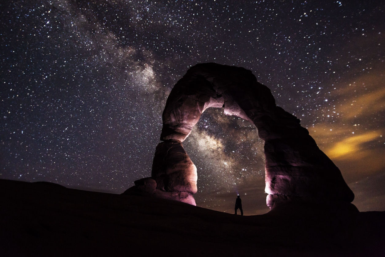 Stone arch in front of the milky way galaxy